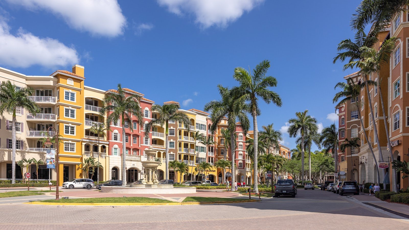 A palm-lined street of shops and restaurants in downtown Naples