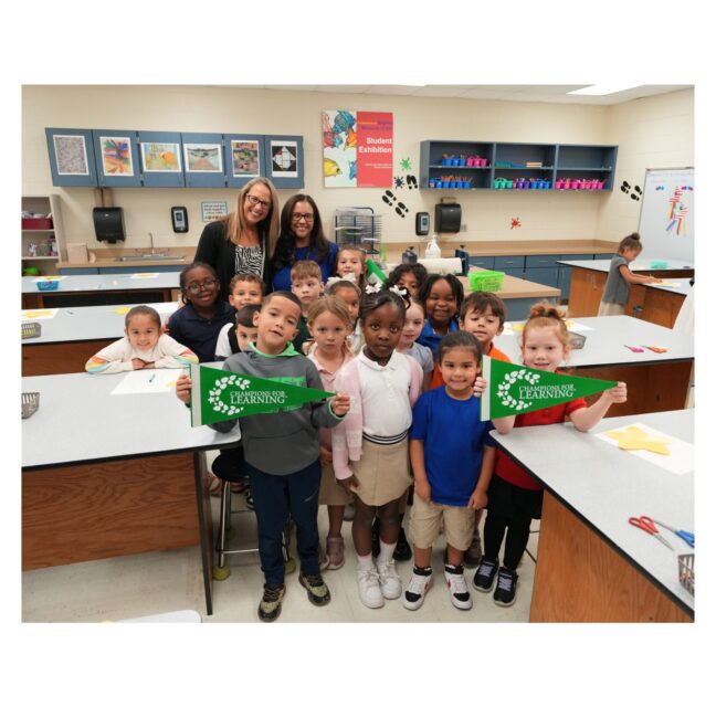 Arlen Smith's Sabal Palm Elementary class holding their Champions For Learning grant awards
