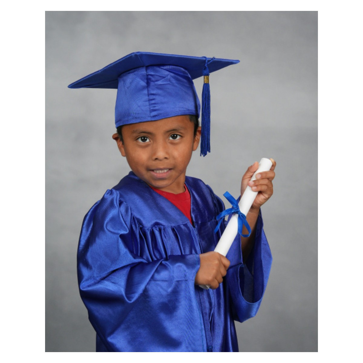 Santiago in a cap and gown holding his Pathways graduation diploma