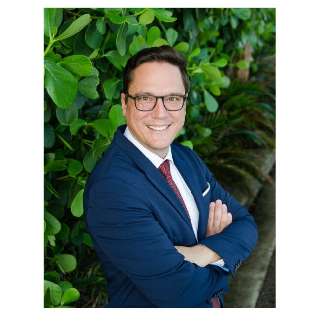 Naples family law attorney Russell Knight in a navy suit and red tie