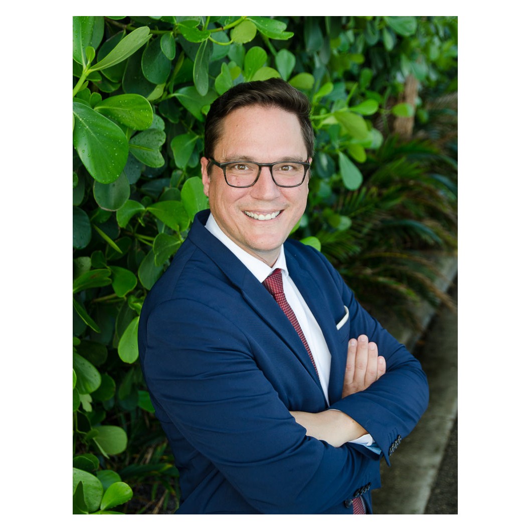 Naples family law attorney Russell Knight in a navy suit and red tie