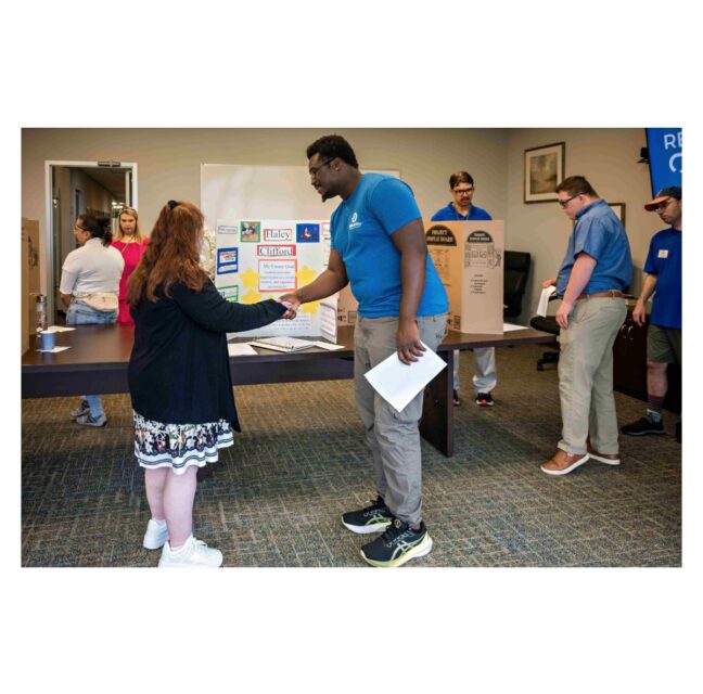 STARability participant Haley C. practices professional etiquette with Woodly Charles