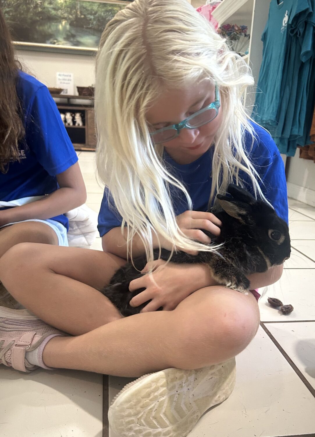 Girl cradling Punkin the rabbit during a bunny program