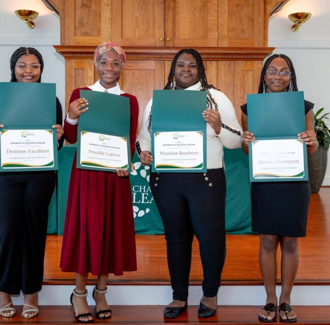 Four students holding certificates at the Champions For Learning induction ceremony