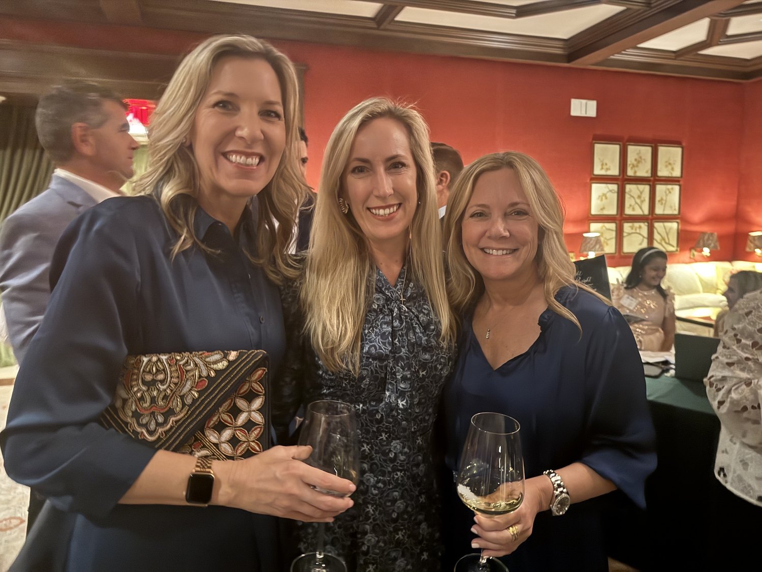 Three women with wine glasses at the Pathways gala