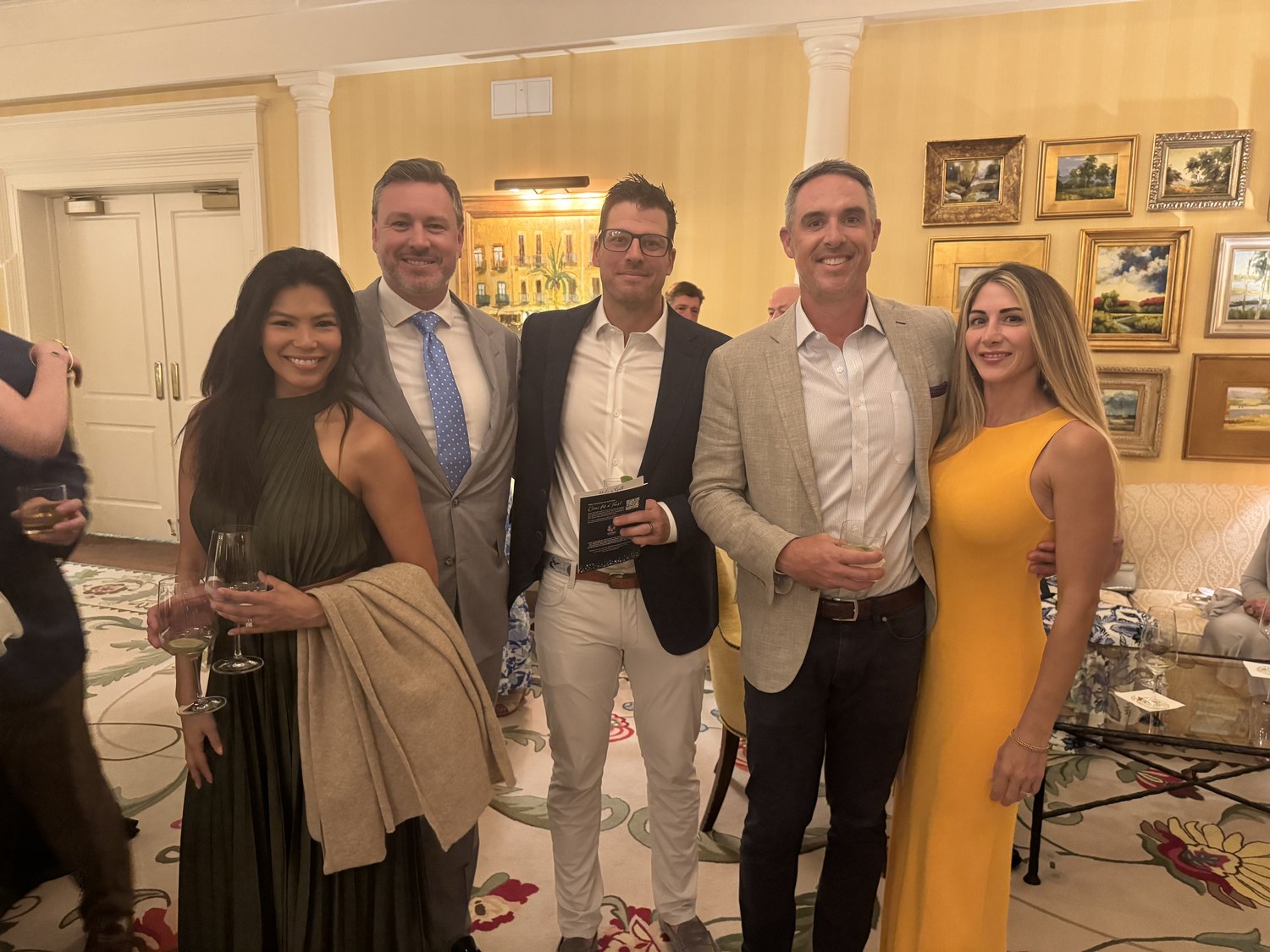 Five guests posing together at the Pathways gala reception