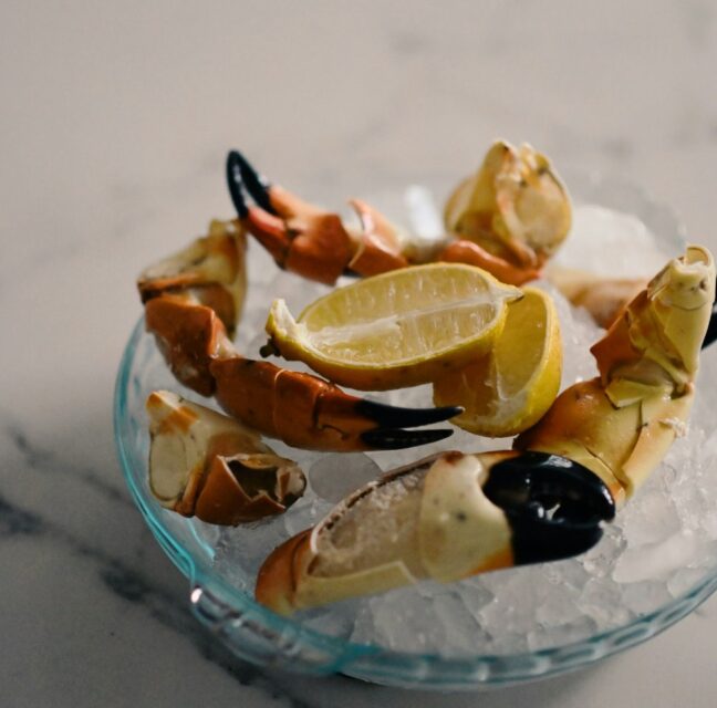 Stone crab claws with lemon on ice. Photo: Blake Wisz / Unsplash